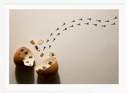 A conceptual art piece showing a broken brown eggshell against a beige background. Inside the shell are black tally marks, as if counting days. A trail of tiny black chicken footprints leads away from the egg, suggesting a chick has finally hatched and escaped after a long wait. Artwork