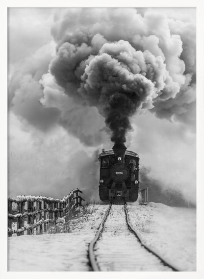 A dramatic black and white photograph of a vintage steam train on tracks in a snowy landscape, viewed from a low angle. A massive, powerful plume of dark smoke billows from the smokestack, filling the sky. Decor
