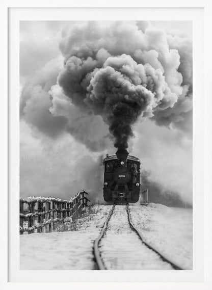 A dramatic black and white photograph of a vintage steam train on tracks in a snowy landscape, viewed from a low angle. A massive, powerful plume of dark smoke billows from the smokestack, filling the sky. Decor