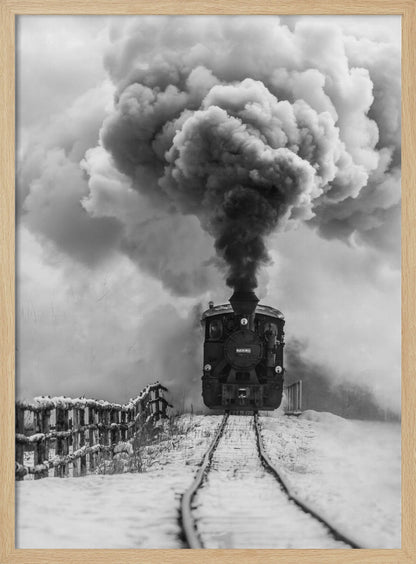 A dramatic black and white photograph of a vintage steam train on tracks in a snowy landscape, viewed from a low angle. A massive, powerful plume of dark smoke billows from the smokestack, filling the sky. Decor