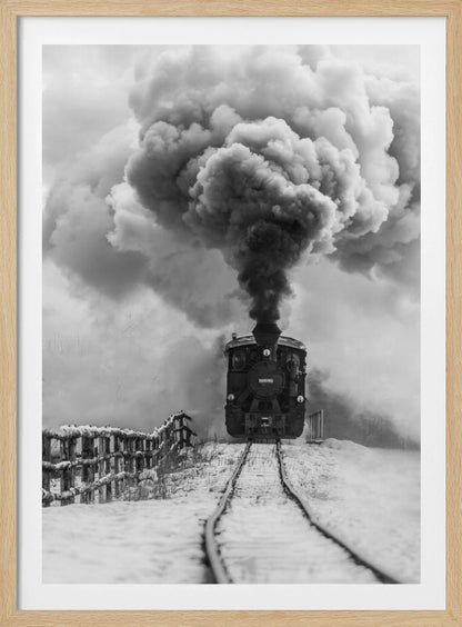 A dramatic black and white photograph of a vintage steam train on tracks in a snowy landscape, viewed from a low angle. A massive, powerful plume of dark smoke billows from the smokestack, filling the sky. Decor