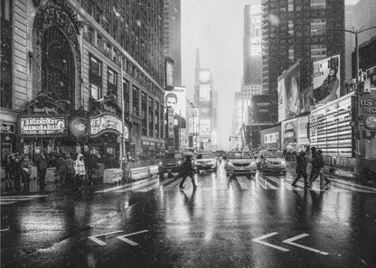 A moody black and white photograph of a snowy day in New York City's Times Square. The wet streets reflect the bright lights of the surrounding buildings and billboards as pedestrians cross the street and cars wait in traffic. Artwork