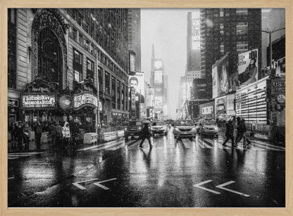 A moody black and white photograph of a snowy day in New York City's Times Square. The wet streets reflect the bright lights of the surrounding buildings and billboards as pedestrians cross the street and cars wait in traffic. Artwork