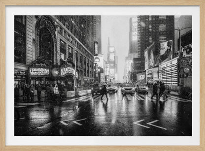 A moody black and white photograph of a snowy day in New York City's Times Square. The wet streets reflect the bright lights of the surrounding buildings and billboards as pedestrians cross the street and cars wait in traffic. Artwork