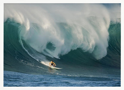 A lone surfer in a yellow shirt rides down the face of an enormous, powerful ocean wave as it crests into white foam, viewed within a silver picture frame. Wall Art