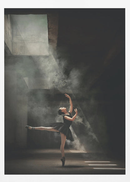 A ballerina in a black tutu gracefully performs an arabesque in a vast, dark, industrial space filled with smoke, dramatically illuminated by shafts of light from above. Poster