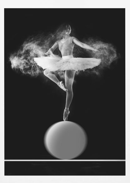 A dramatic black and white photograph of a ballerina balancing on one pointe shoe on top of a large sphere. She wears a white tutu and is surrounded by a cloud of white powder, capturing a moment of explosive, graceful movement against a solid black background. Wall Art