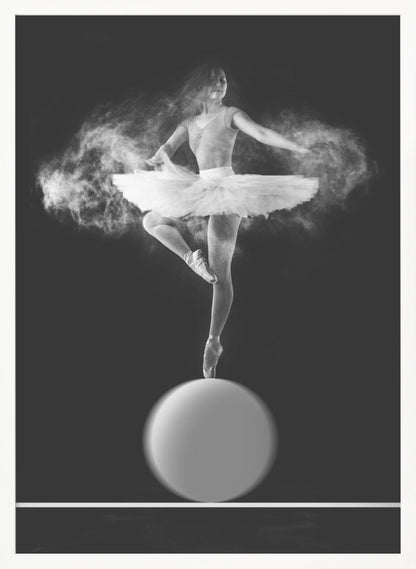 A dramatic black and white photograph of a ballerina balancing on one pointe shoe on top of a large sphere. She wears a white tutu and is surrounded by a cloud of white powder, capturing a moment of explosive, graceful movement against a solid black background. Wall Art