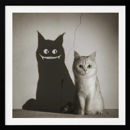 A photographic artwork of a cute, silver-grey cat with vibrant green eyes sitting beside its shadow, which is distorted into a monstrous black creature with large white eyes and a sharp, toothy grin against a cracked wall. Decor