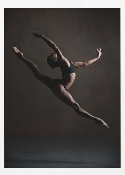 A dramatic, low-key studio photograph of a muscular female dancer captured mid-leap. She is in a full split, arching her back with her arms extended gracefully. The lighting accentuates her toned physique against a dark, textured brown background. Poster