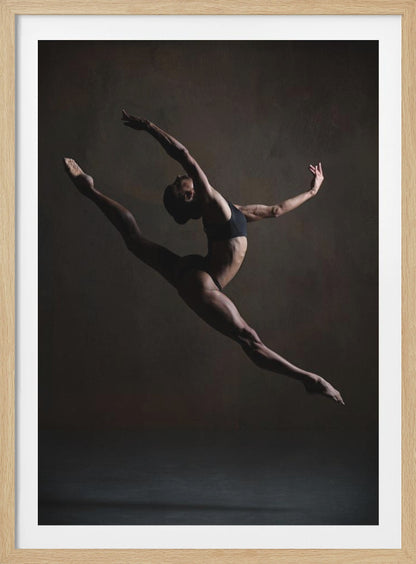 A dramatic, low-key studio photograph of a muscular female dancer captured mid-leap. She is in a full split, arching her back with her arms extended gracefully. The lighting accentuates her toned physique against a dark, textured brown background. Poster