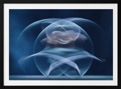 An abstract long-exposure photograph of a spinning dancer, creating ethereal, intersecting trails of blue and white light that form a glowing, orb-like shape against a deep blue background. The image is presented within a silver frame. Poster