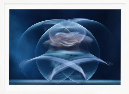 An abstract long-exposure photograph of a spinning dancer, creating ethereal, intersecting trails of blue and white light that form a glowing, orb-like shape against a deep blue background. The image is presented within a silver frame. Poster
