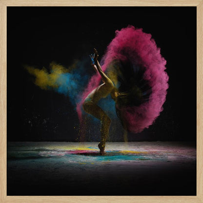 A dynamic photo of a dancer arching backward, their long hair creating a massive arc of vibrant pink powder against a black background, with smaller bursts of blue and yellow. Decor