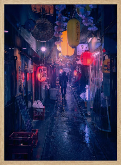 A lone figure walks down a narrow, rain-slicked Japanese alley at night. Colorful paper lanterns hang overhead, casting warm orange and red light that reflects on the wet ground, contrasting with the cool blue tones of the evening. Wall Art
