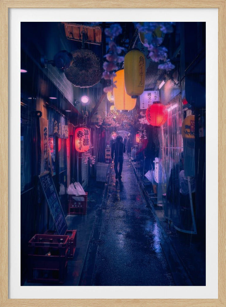 A lone figure walks down a narrow, rain-slicked Japanese alley at night. Colorful paper lanterns hang overhead, casting warm orange and red light that reflects on the wet ground, contrasting with the cool blue tones of the evening. Wall Art