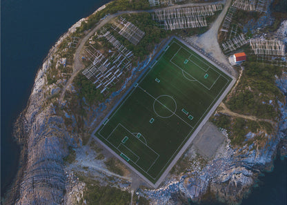 An art print featuring a distant view of a football field under a wide sky, evoking a sense of space and tranquility. Wall Art