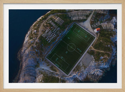 An art print featuring a distant view of a football field under a wide sky, evoking a sense of space and tranquility. Wall Art