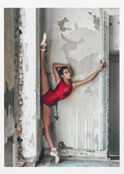 A ballerina in a shiny red leotard performs a standing split against a distressed, peeling wall. Her left leg is extended straight up, and her body leans against the wall in a display of incredible flexibility and grace amidst a rustic, derelict setting. Artwork
