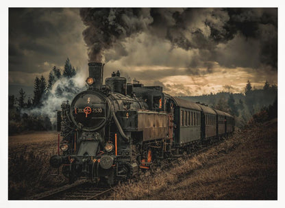 A powerful black steam locomotive on a railway track, billowing thick dark smoke into a dramatic, cloudy sky. The train travels through a rustic, grassy landscape, and the image has a warm, vintage color tone, all within a silver frame. Wall Art