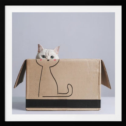 A cute white cat with green eyes peeks out of a cardboard box. The front of the box has a simple black line drawing of a cat's body, making it look as if the real cat's head belongs to the drawing. The image is set against a light gray background and enclosed in a light wood frame. Wall Art