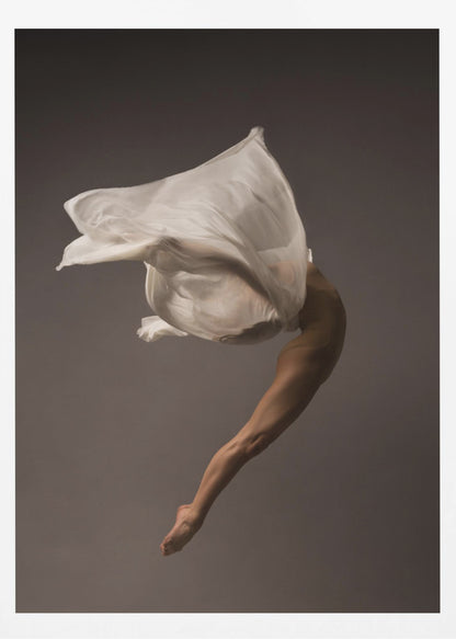 A minimalist fine art photograph of a dancer in mid-air against a solid grey background. The dancer's body is arched backwards, with a large piece of flowing white fabric enveloping their torso and creating a sense of dynamic, weightless motion. Only their muscular leg and pointed foot are clearly visible, emphasizing grace and form. Wall Art