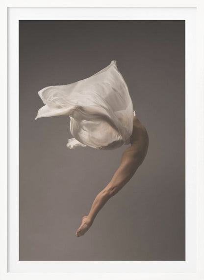 A minimalist fine art photograph of a dancer in mid-air against a solid grey background. The dancer's body is arched backwards, with a large piece of flowing white fabric enveloping their torso and creating a sense of dynamic, weightless motion. Only their muscular leg and pointed foot are clearly visible, emphasizing grace and form. Wall Art