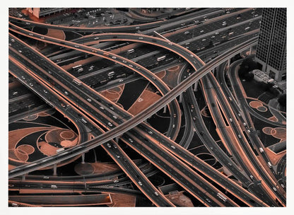 A framed aerial photograph of a sprawling, multi-level highway interchange presented in a selective color style. Dark grey roads weave over and under each other, while the surrounding land is a contrasting copper-brown, creating a dramatic and complex urban pattern. Poster