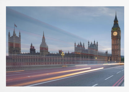A framed, long-exposure photograph of London's Big Ben and the Houses of Parliament at dusk. In the foreground, streaks of red and yellow light from moving traffic blur across a bridge, creating a dynamic contrast with the historic architecture against a twilight sky. Decor