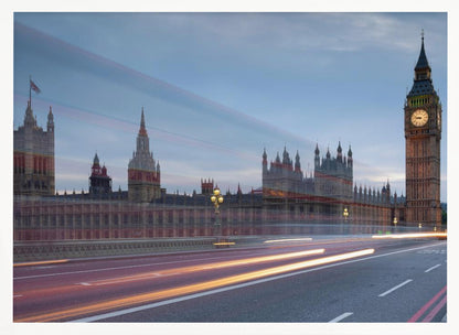 A framed, long-exposure photograph of London's Big Ben and the Houses of Parliament at dusk. In the foreground, streaks of red and yellow light from moving traffic blur across a bridge, creating a dynamic contrast with the historic architecture against a twilight sky. Decor