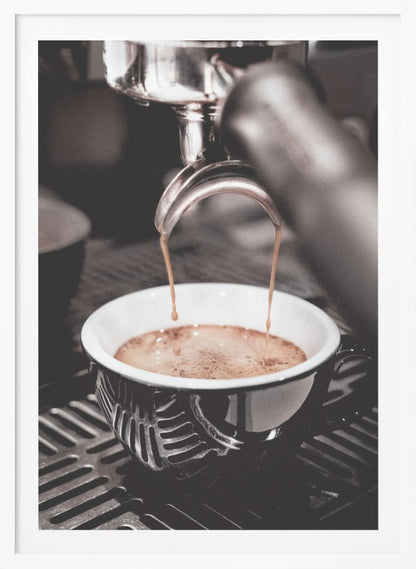 A close-up, desaturated photograph of an espresso machine pouring two streams of rich brown coffee from a chrome portafilter into an ornate black and white cup. Poster