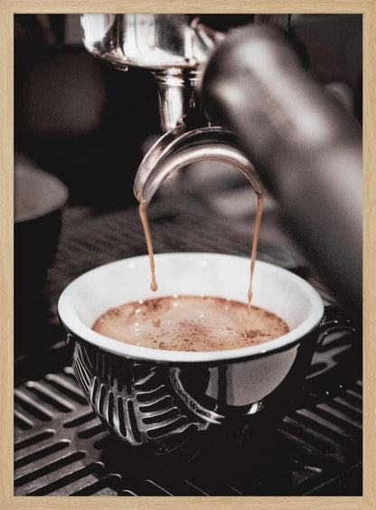 A close-up, desaturated photograph of an espresso machine pouring two streams of rich brown coffee from a chrome portafilter into an ornate black and white cup. Poster
