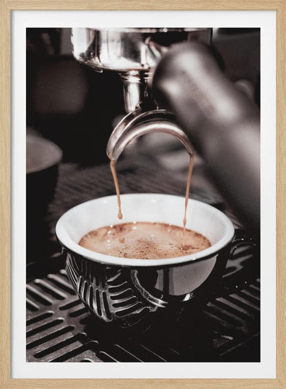 A close-up, desaturated photograph of an espresso machine pouring two streams of rich brown coffee from a chrome portafilter into an ornate black and white cup. Poster