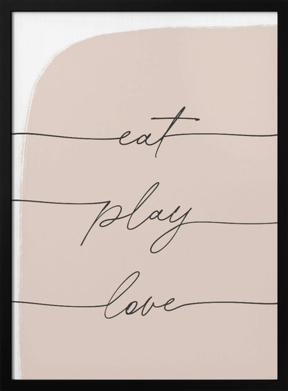 A modern typographic art print in a black frame. The words 'eat', 'play', and 'love' are written in a black cursive script, each on a separate line against a pale pink painted background. Print
