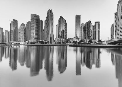 A framed black and white photograph of the Dubai Marina skyline, with its modern skyscrapers perfectly reflected in the calm water of the canal. Decor