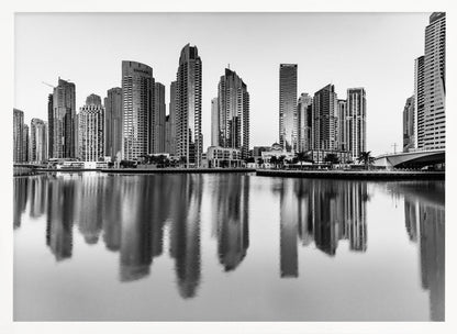 A framed black and white photograph of the Dubai Marina skyline, with its modern skyscrapers perfectly reflected in the calm water of the canal. Decor