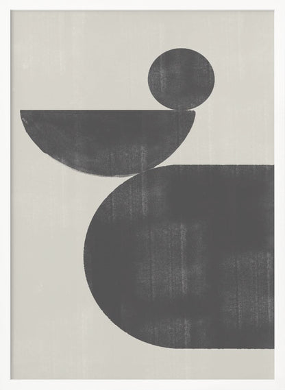 A minimalist abstract artwork featuring three charcoal black shapes stacked against a light beige textured background. At the bottom is a large, rounded shape, on which a semi-circle is balanced. A smaller, full circle rests on top of the semi-circle, creating a sense of precarious balance. The piece is enclosed in a simple black frame. Decor