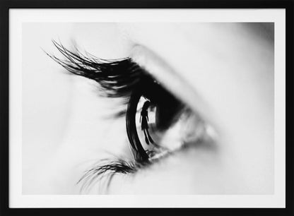 A dramatic black and white macro photograph of a human eye in profile, with a surreal reflection of a person's silhouette visible in the pupil. Print