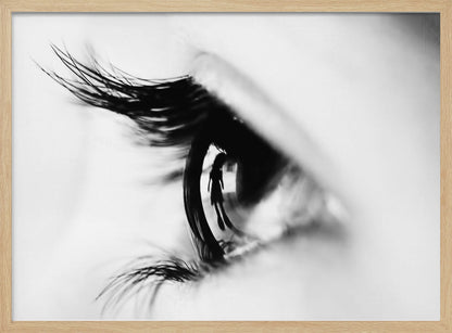 A dramatic black and white macro photograph of a human eye in profile, with a surreal reflection of a person's silhouette visible in the pupil. Print