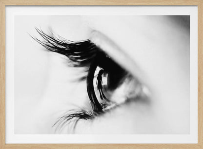 A dramatic black and white macro photograph of a human eye in profile, with a surreal reflection of a person's silhouette visible in the pupil. Print