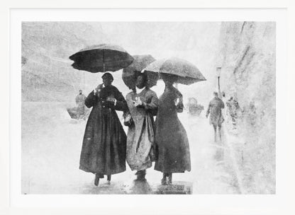 A vintage black and white photograph in a silver frame, depicting three people in long dark coats walking together under umbrellas during a heavy snow or rain storm on a city street. The image has a grainy, textured quality, giving it an old-fashioned, artistic feel. Poster