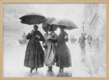 A vintage black and white photograph in a silver frame, depicting three people in long dark coats walking together under umbrellas during a heavy snow or rain storm on a city street. The image has a grainy, textured quality, giving it an old-fashioned, artistic feel. Poster