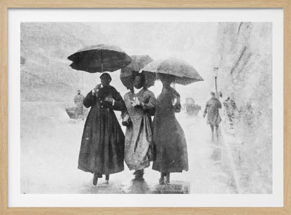 A vintage black and white photograph in a silver frame, depicting three people in long dark coats walking together under umbrellas during a heavy snow or rain storm on a city street. The image has a grainy, textured quality, giving it an old-fashioned, artistic feel. Poster