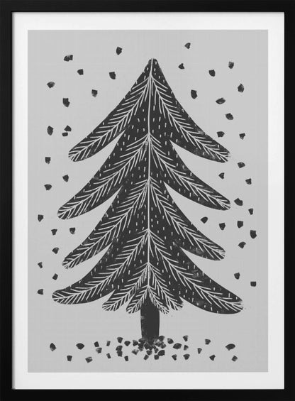 A black and white block print illustration of a stylized Christmas tree against a light gray background. Black specks representing falling snow surround the tree. The artwork has a rustic, folk art feel and is presented in a black frame. Print