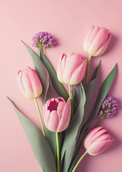 A top-down, artistic illustration of a bouquet of pink tulips and small purple flowers with long green leaves, arranged against a solid light pink background and displayed within a thin black frame. Wall Art