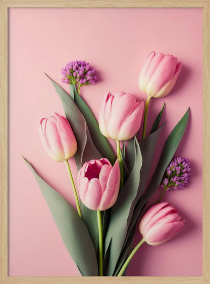 A top-down, artistic illustration of a bouquet of pink tulips and small purple flowers with long green leaves, arranged against a solid light pink background and displayed within a thin black frame. Wall Art