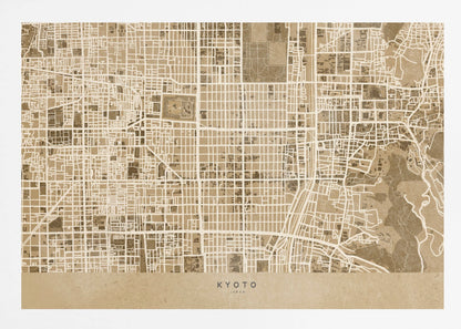 A framed, stylized map of Kyoto, Japan, in shades of brown and beige. The city streets are illustrated as a complex grid of off-white lines against a textured brown background. At the bottom, a solid beige banner contains the text 'KYOTO' and 'JAPAN' in a modern sans-serif font. The artwork is surrounded by a brushed silver frame. Artwork