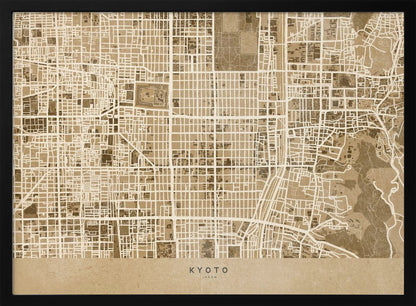 A framed, stylized map of Kyoto, Japan, in shades of brown and beige. The city streets are illustrated as a complex grid of off-white lines against a textured brown background. At the bottom, a solid beige banner contains the text 'KYOTO' and 'JAPAN' in a modern sans-serif font. The artwork is surrounded by a brushed silver frame. Artwork