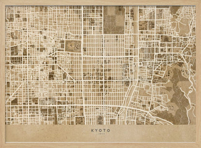 A framed, stylized map of Kyoto, Japan, in shades of brown and beige. The city streets are illustrated as a complex grid of off-white lines against a textured brown background. At the bottom, a solid beige banner contains the text 'KYOTO' and 'JAPAN' in a modern sans-serif font. The artwork is surrounded by a brushed silver frame. Artwork