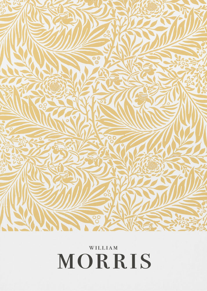 A framed exhibition-style poster of a William Morris design. The poster features an intricate, golden-yellow floral and leaf pattern on a white background. Below the pattern, the name 'WILLIAM MORRIS' is printed in black text. The entire artwork is presented in a simple black frame. Wall Art